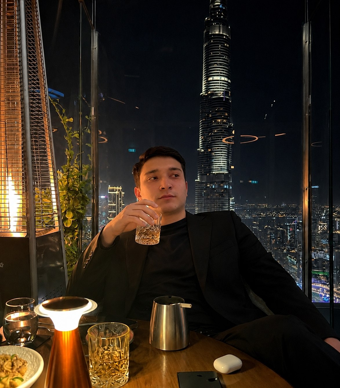 Javlon seated at a restaurant overlooking the city